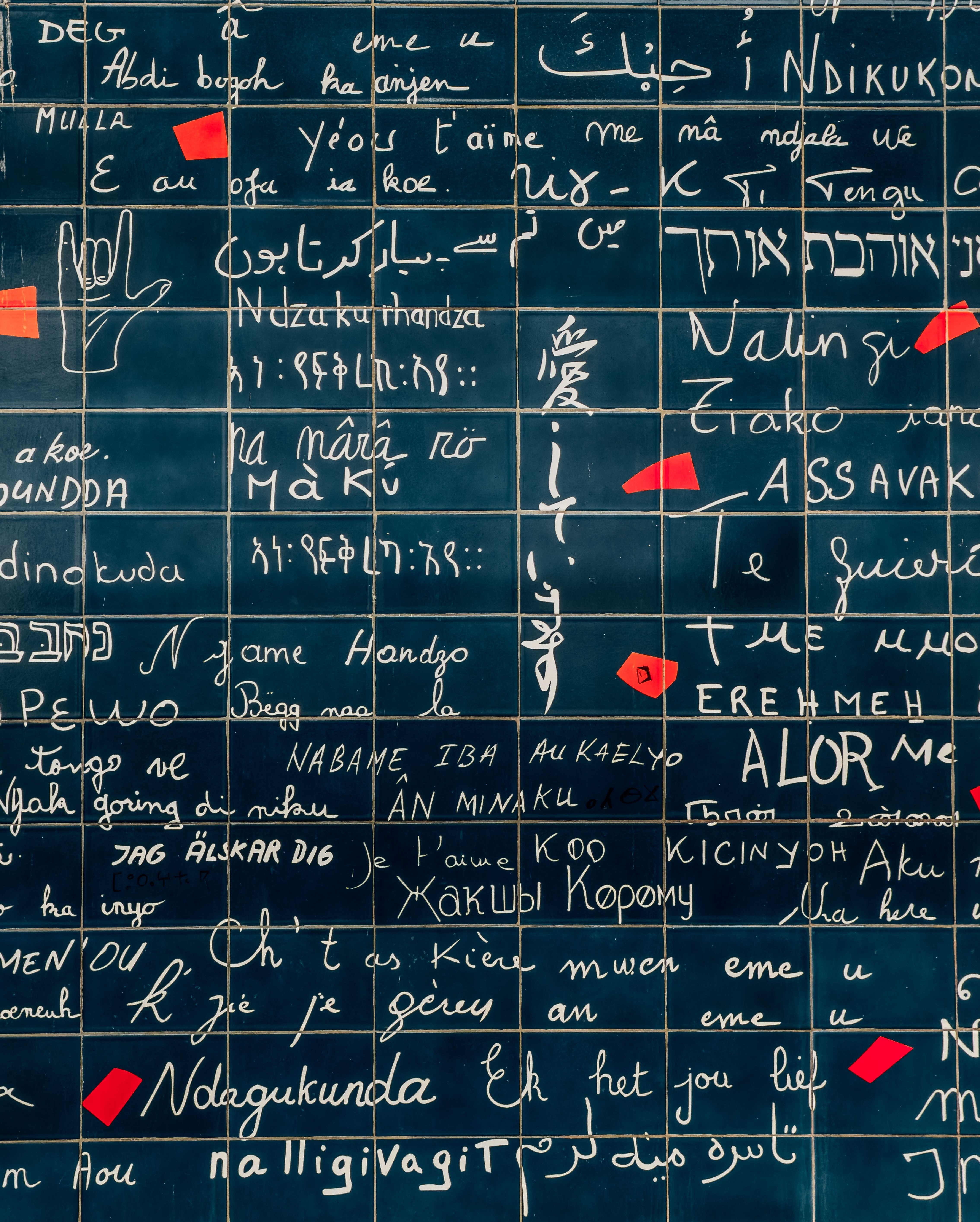 The Love Wall in Montmartre, Paris, displaying 'I Love You' in multiple languages on blue tiles